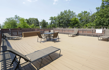 A wooden deck with a table and chairs.